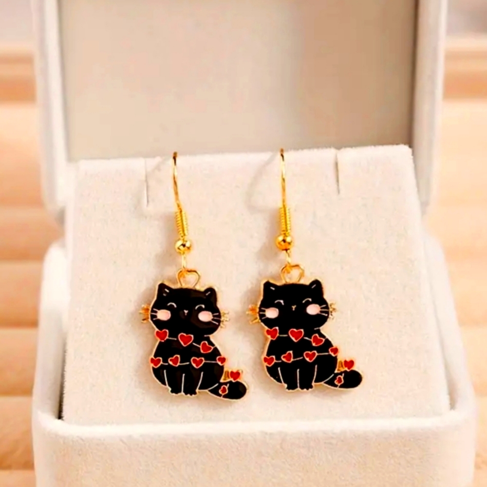 Black kitten earrings with heart string lights wrapped around